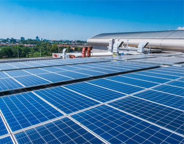 Photovoltaikanlage auf dem Dach eines Industriebetriebs aus der Vogelperspektive