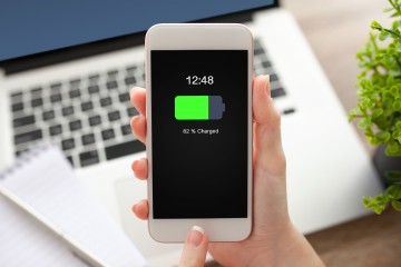 Smartphone vor dem Laptop beim Laden