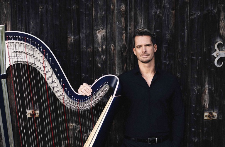 Der Musiker Xavier De Maistre steht neben seiner Harfe. Copyright: Nikolaj Lund