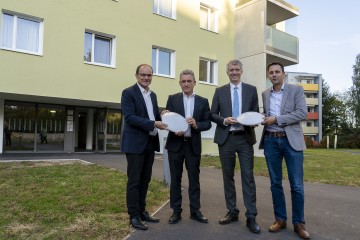 Vorstandsdirektor Josef Siligan mit 3 weiteren Herren, welche Beleuchtungskörper in den Händen halten.