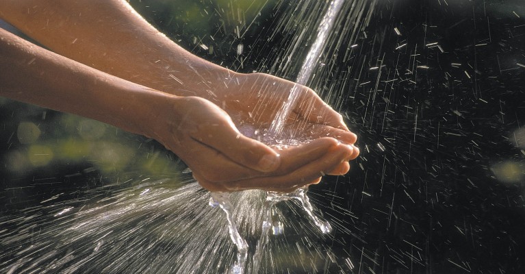 Hände fangen Wasserstrahl auf